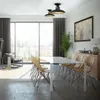 A modern dining room with a large window overlooking a city skyline, featuring a dining table and chairs, a sideboard, and a floor lamp. Produktbild-Vorschau
