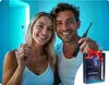 A couple smiling and holding toothbrushes, with a product box in the foreground. Náhled obrázku produktu