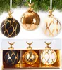 Three Christmas ornaments with gold deer heads are displayed hanging from a pine branch, and then in a gift box. Podgląd zdjęcia produktu
