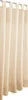 A close-up view of beige curtains hanging on a curtain rod. Náhled obrázku produktu