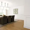 A dining room with a wooden table and chairs, artwork on the wall, and wooden flooring. Náhled obrázku produktu