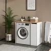 A laundry room scene with a washing machine cabinet, a plant, and laundry supplies. Náhled obrázku produktu