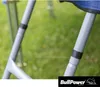 Close-up of two gray legs of a camping chair or similar outdoor furniture, with a blurred green grassy background. A black band is visible on each leg. A blue fabric is visible at the top of one leg. Produktbild-Vorschau