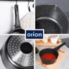 A collage of four images showing different views of a black saucepan with a speckled interior, including its handle, bottom, and interior with ketchup. The brand logo 'orion' is visible. Náhled obrázku produktu