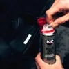 A person is using a K2 Benzin GO! injector cleaner product. Podgląd zdjęcia produktu