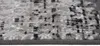 A close-up view of a rug with a distressed pattern in shades of gray, black, and white. Produktbild-Vorschau