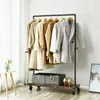 A clothing rack with several coats and two storage bins on the shelf below. Náhled obrázku produktu