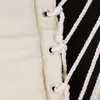 A close-up view of a beige fabric hammock chair with white rope details and black stripes. Produktbild-Vorschau