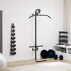 A home gym setup with a wall-mounted lat pulldown machine, dumbbells, and weight plates. Produktbild-Vorschau