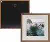 A framed picture of a misty forest landscape is shown next to the back of a similar frame. Produktbild-Vorschau