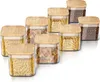 A set of glass storage jars with bamboo lids, filled with various dry goods like pasta and coffee beans, arranged on a white background. Anteprima dell’immagine prodotto