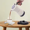 A hand is pouring coffee from a moka pot into a cup on a wooden table, with a cookie and spoon nearby. Náhled obrázku produktu