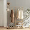 A bamboo garment rack with clothes, a hat, and a handbag. Anteprima dell’immagine prodotto