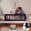 A father and child are in a bedroom, with the child in a bed protected by a bed rail. Anteprima dell’immagine prodotto