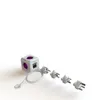A white cube-shaped power adapter with purple accents and multiple plug adapters on a white background. Produktbild-Vorschau