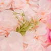 A close-up view of artificial pink flowers and green leaves. Podgląd zdjęcia produktu