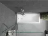 A top-down view of a modern bathroom featuring a white bathtub, a glass shower screen, and gray tiled walls. Náhled obrázku produktu