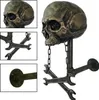 A collage of images showing a skull-shaped wall mount with wrenches and a pipe fixture. Produktbild-Vorschau