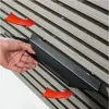 A hand is shown installing a black shelf onto a slatted wall. Red arrows indicate the direction of movement. Produktbild-Vorschau