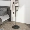 A coat rack is placed next to a bed in a bedroom. Produktbild-Vorschau