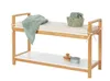 A wooden bench with a cushion and a shelf below, decorated with towels and bathroom accessories. Náhled obrázku produktu