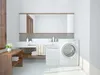 A clean and modern laundry room with a washing machine, laundry basket, and sink. Náhľad obrázku produktu