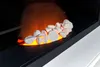 Close-up of an electric fireplace with white stones and glowing orange embers. Náhled obrázku produktu