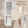 A tall, narrow white cabinet with doors and shelves, shown with dimensions and a silhouette of a person for scale. Also shows a laundry hamper. Voir les images du produit