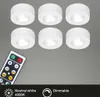 Six white LED puck lights and a remote control are arranged on a gray background. The lights are illuminated, and the remote has various buttons and percentage indicators. Náhľad obrázku produktu