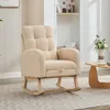 A beige teddy velvet rocking chair with a high back and armrests is shown in a well-lit room with a patterned rug and a small wooden coffee table. Voir les images du produit
