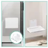 A collage showing a white foldable shower seat mounted on a glass door and a wall. Produktbild-Vorschau