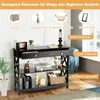 A black console table with drawers and shelves, decorated with various items and featuring text overlays highlighting its features and storage capacity. Produktbild-Vorschau