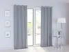 A room with a large window covered by gray curtains, a floor lamp, and a small side table. Produktbild-Vorschau