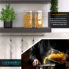 A kitchen scene showing storage jars and someone pouring pasta into a pot. Produktbild-Vorschau