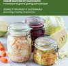 Jars of fermented food with cabbage and carrots, along with whole cabbages and carrots, are arranged on a light-colored surface. Produktbild-Vorschau