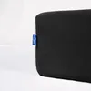 A close-up of a black fabric product with a blue tag attached to the side. Náhled obrázku produktu