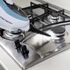 A steam cleaner is being used to clean a gas stove top. Náhled obrázku produktu
