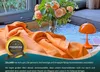 An orange blanket is draped over a table with a vase of flowers and a small orange lamp. Produktbild-Vorschau