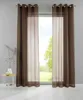 Two brown transparent curtains are hanging in front of a window with a view of greenery outside. A small side table with a vase and a decorative object is placed to the left of the curtains. Produktbild-Vorschau