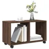 A brown wooden storage unit with wheels, containing books and a vase with flowers on top. Náhled obrázku produktu