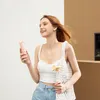 A young woman holding a pink portable fan outdoors. Anteprima dell’immagine prodotto