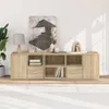 A modern wooden media console with various compartments, decorated with a lamp, artwork, and decorative objects, placed in a well-lit room with a white rug. Voir les images du produit