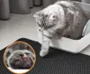 A cat is using a litter box, with a close-up of its paw. Náhled obrázku produktu