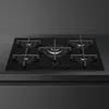 A black gas hob with five burners, set on a countertop against a dark grey wall. Anteprima dell’immagine prodotto