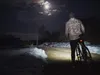 A person with a bicycle at night under the moon. Produktbild-Vorschau