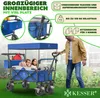 A man is pushing a blue wagon with two children inside, outdoors on grass. Produktbild-Vorschau
