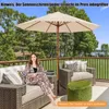 A woman relaxing on a patio furniture set under a large umbrella. Anteprima dell’immagine prodotto