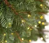 Close-up of a decorated artificial Christmas tree branch with lights. Produktbild-Vorschau