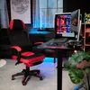 A gaming setup with a chair, desk, computer, and monitor in a room with ambient lighting. Produktbild-Vorschau