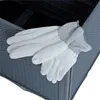 A pair of white gardening gloves with gray cuffs rests on the edge of a dark gray rattan-look raised garden bed. Produktbild-Vorschau